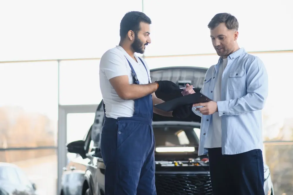 Premier Automotive technician greeting a customer during a vehicle service visit in San Angelo, TX