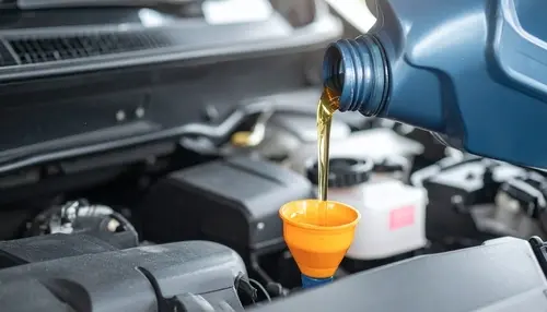 Technician performing engine oil and fluid maintenance service