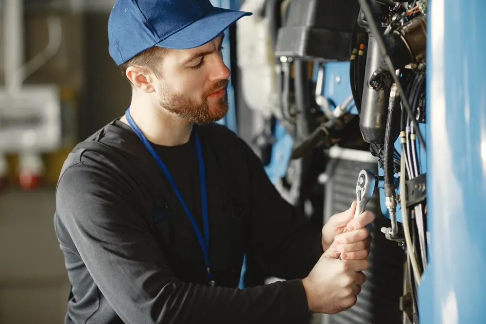 Light-duty work truck receiving mechanical repair service in shop bay