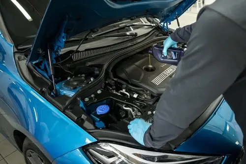 Technician running computer diagnostics on a vehicle engine